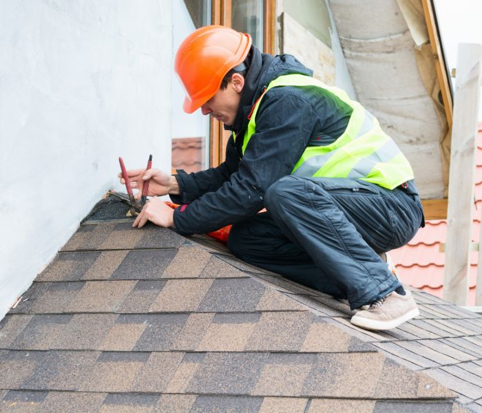 Roof contractor taking roof measurements for inspection in Staten Island